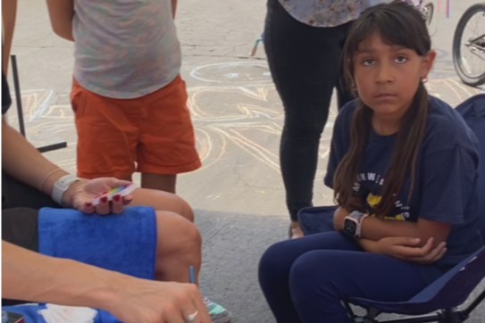 Kids playing a game and coloring using chalk and paint